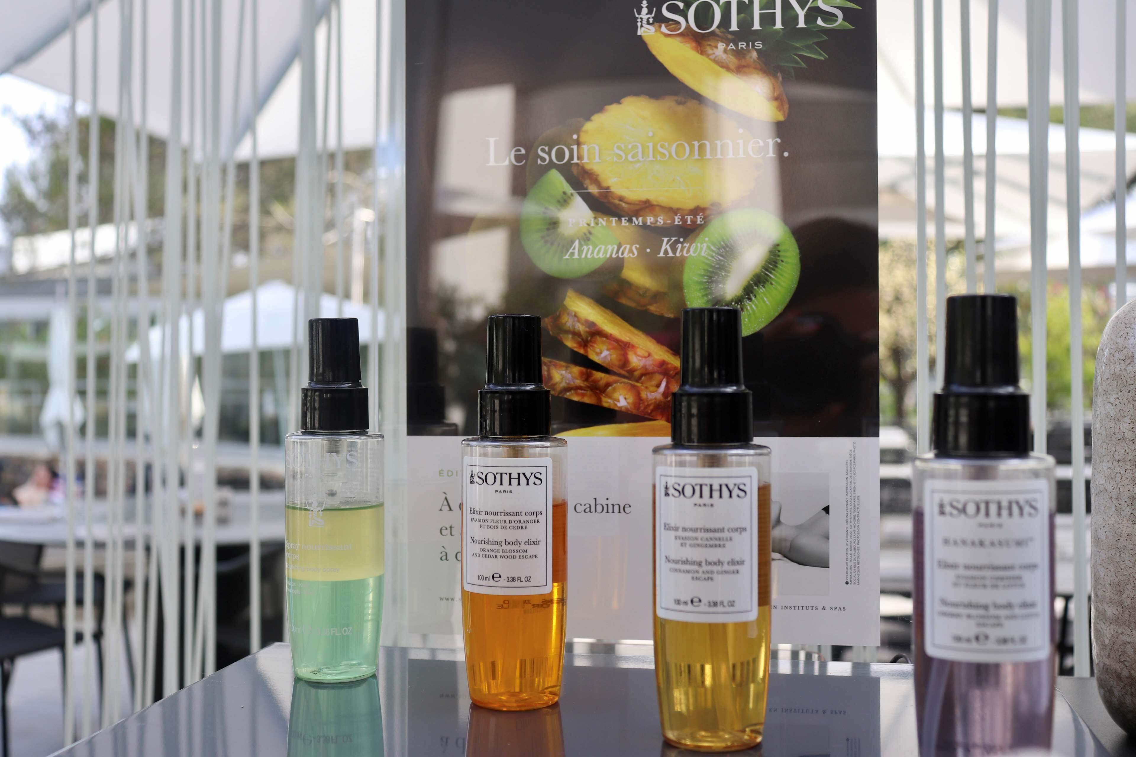 A table with four bottles of Sothys Paris skincare products.