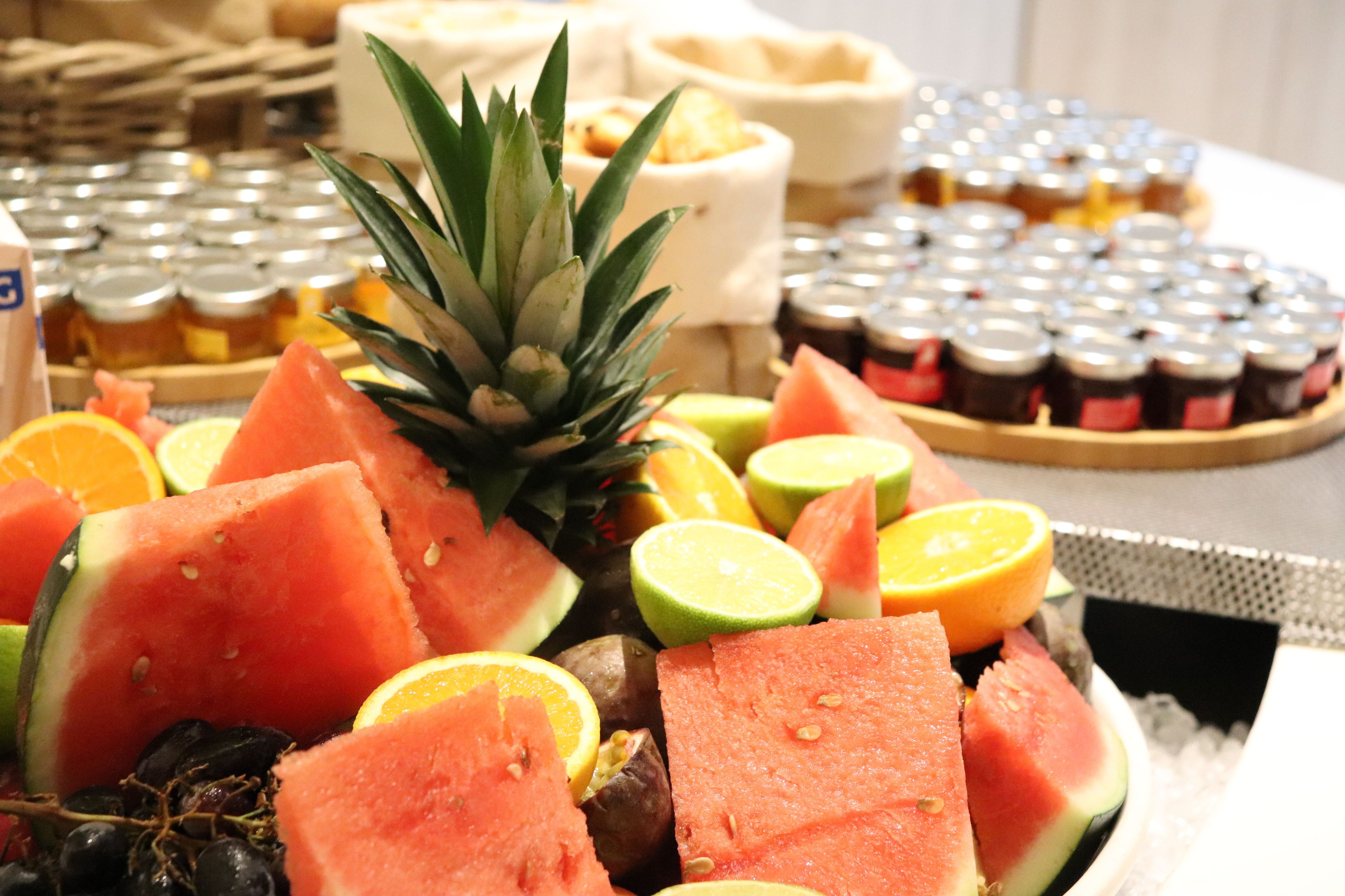 A fruit platter with watermelon, pineapple, and citrus fruits.