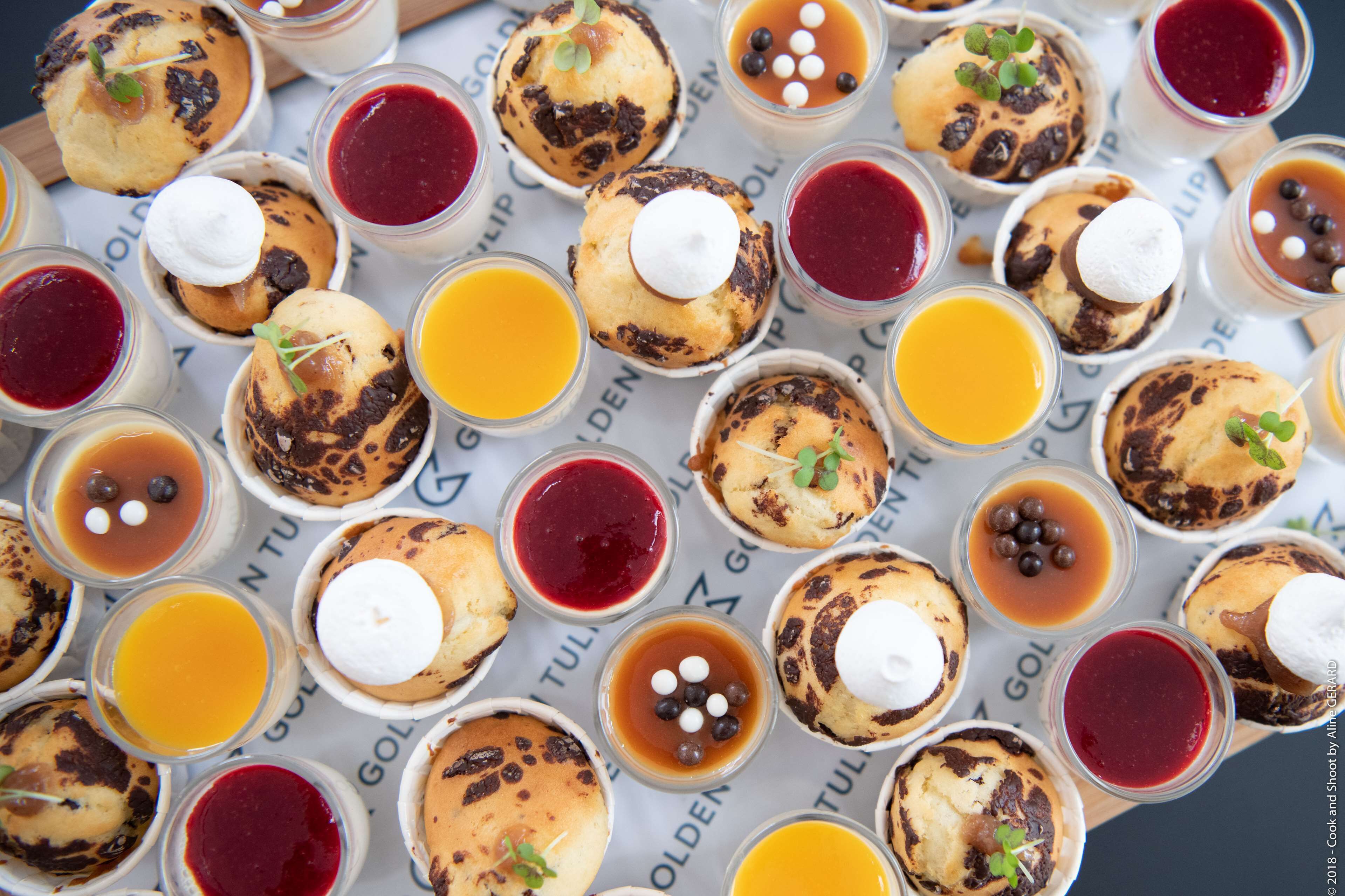 A variety of desserts and beverages arranged on a table.