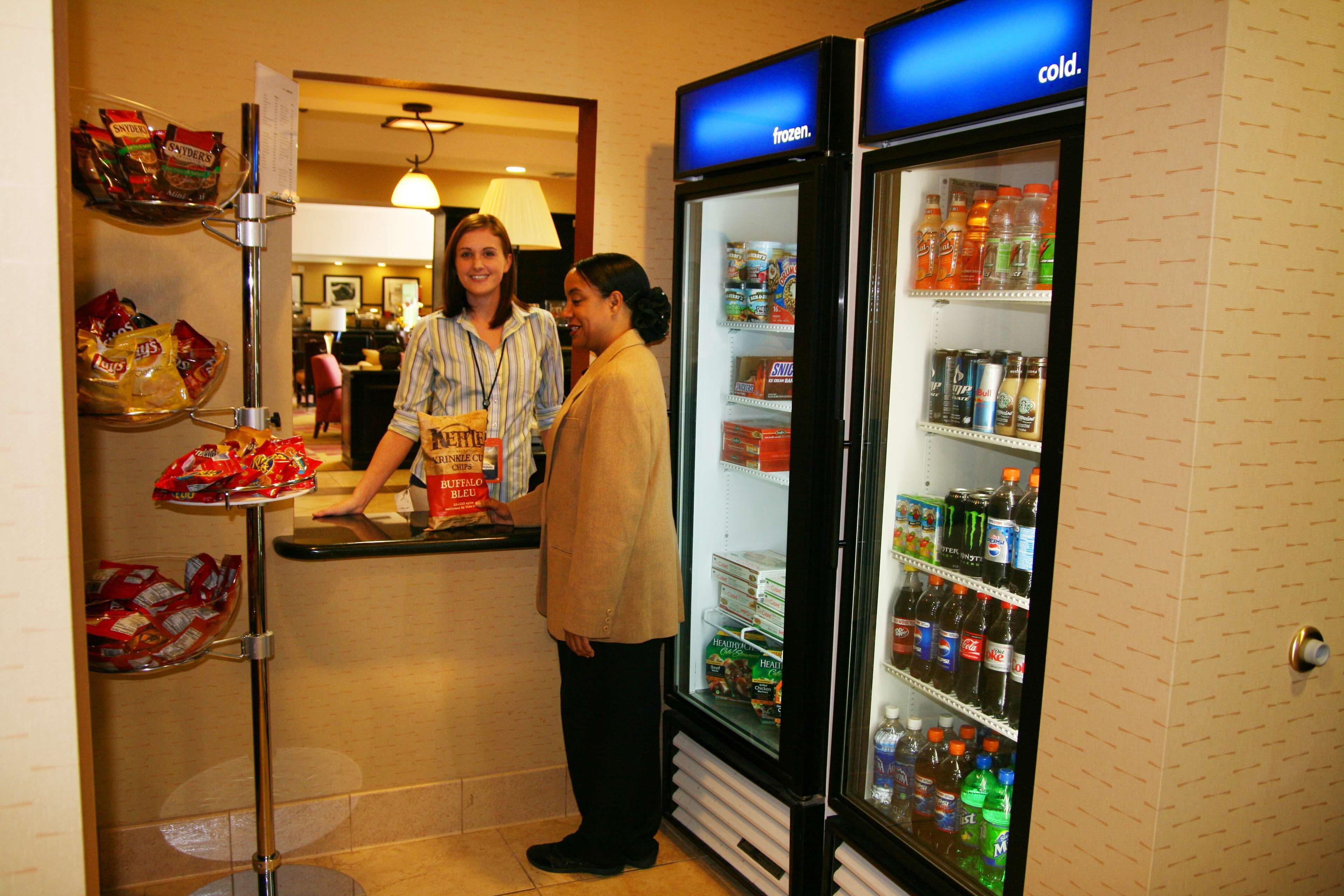 A vending machine with snacks and a refrigerator stocked with beverages.