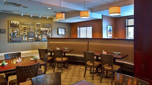 A restaurant with booths, tables, and chairs.