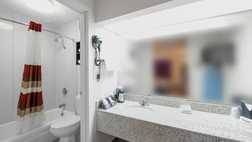 A bathroom with a shower, toilet, and sink.