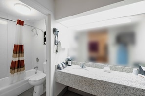 A bathroom with a shower, toilet, and sink. - Red Roof Inn Walterboro (Walterboro)