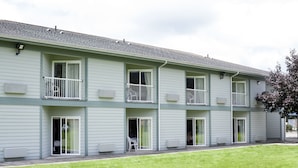 A multi-story building with a flat roof, exterior windows, and balconies. - The Dew Drop Inn Motel (Forks)