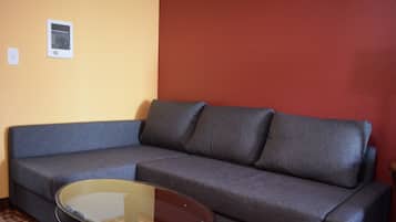 Deluxe Suite 2 King Beds Kitchenette No Pets | Living room | Flat-screen TV