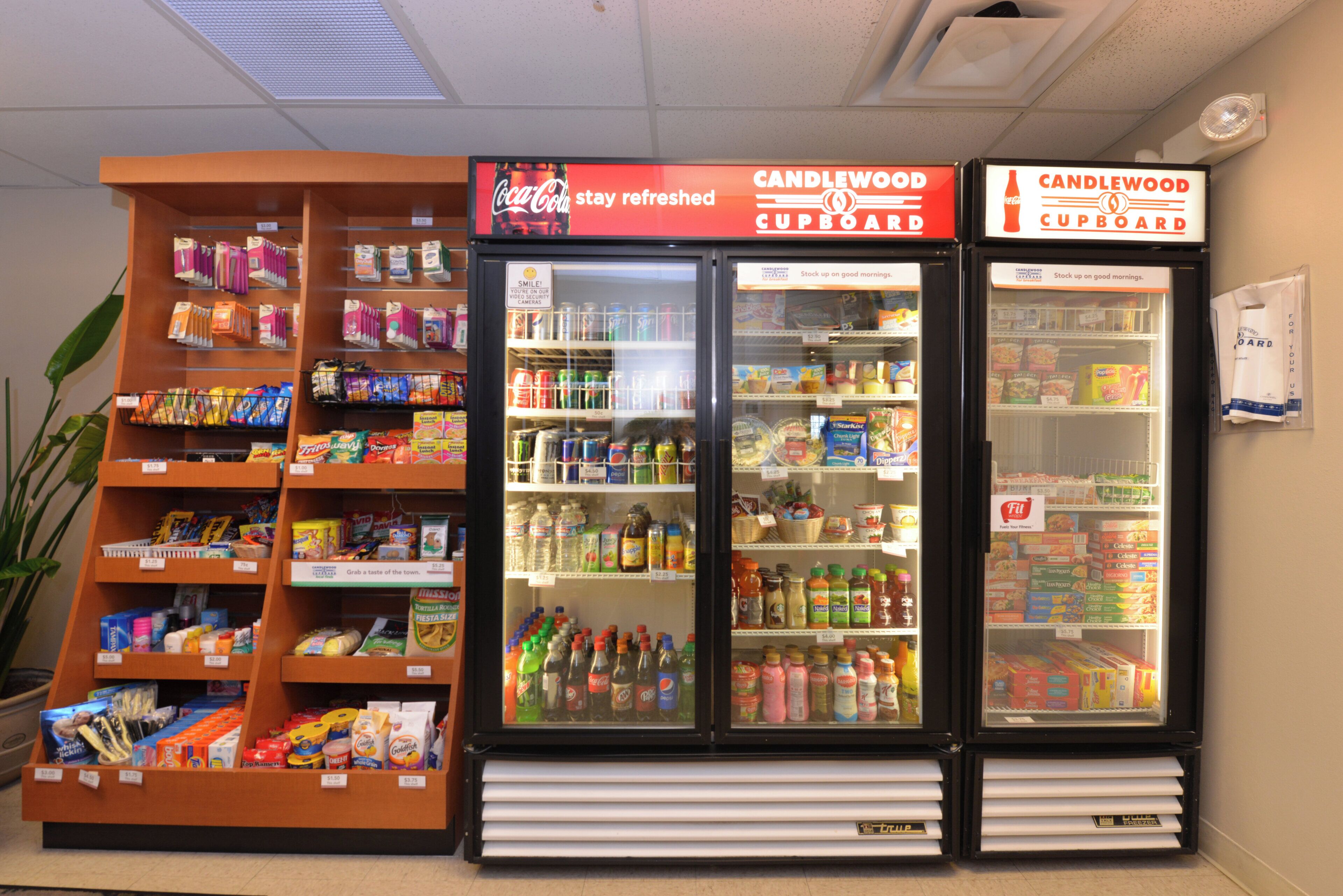A vending machine with a Coca-Cola sign, stocked with various beverages.