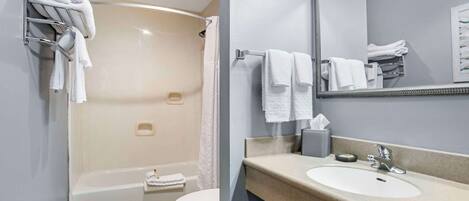 A modern bathroom with a bathtub, toilet, and sink.