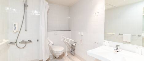 A modern bathroom with a shower, toilet, and sink.