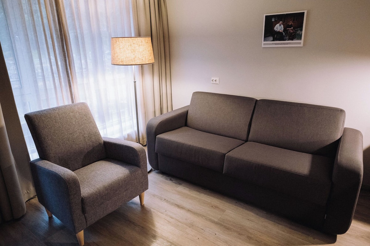 family room | 1 bedroom, desk, laptop workspace, iron/ironing board