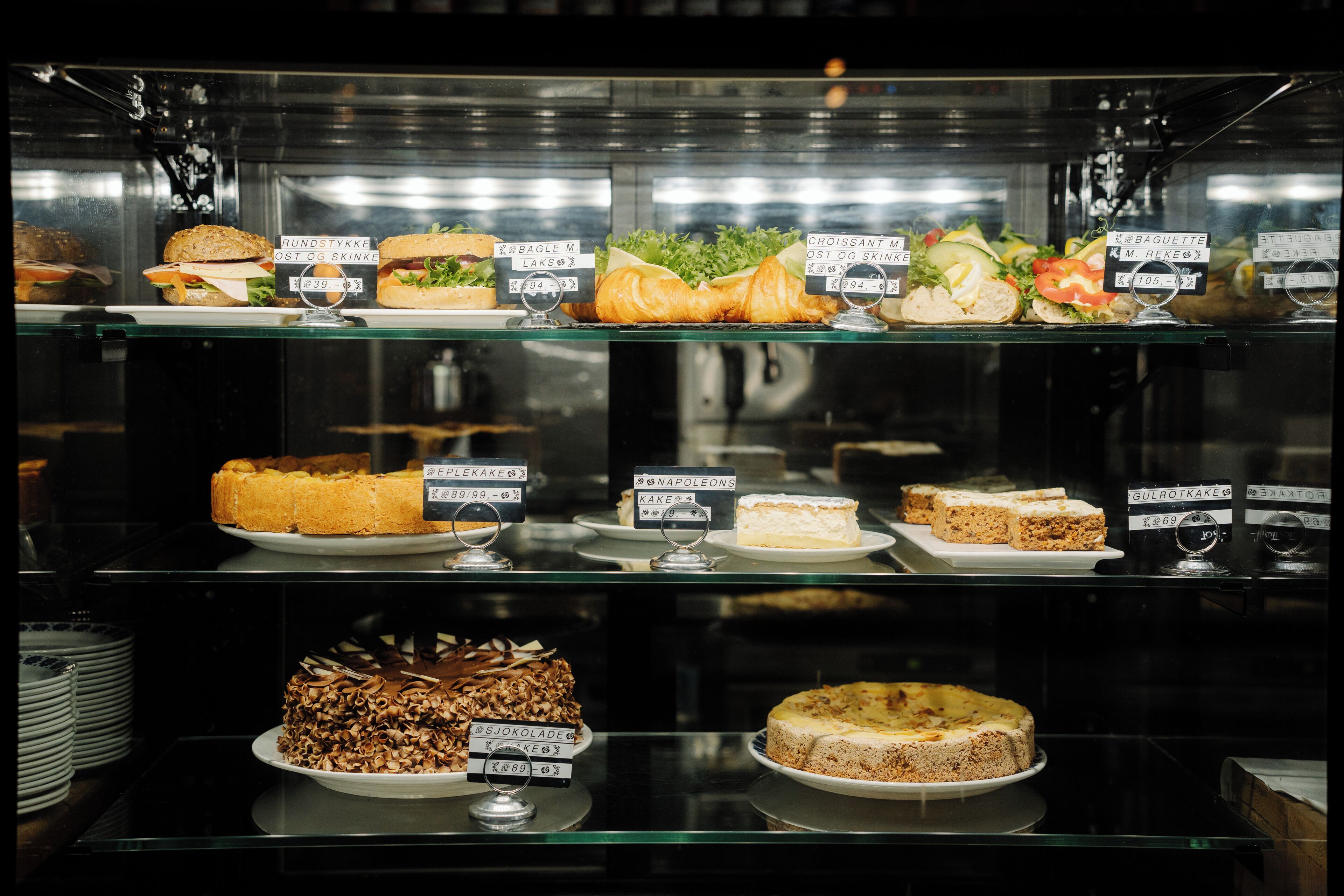 A bakery display case with various baked goods and desserts.