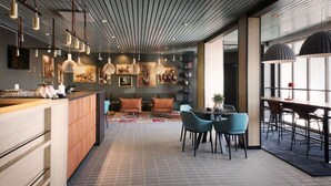 A modern interior with a bar area, seating, and artwork.