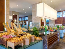 A buffet with various baked goods and pastries.