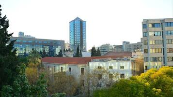 A cityscape with modern buildings, including a tall skyscraper and several mid-rise structures.
