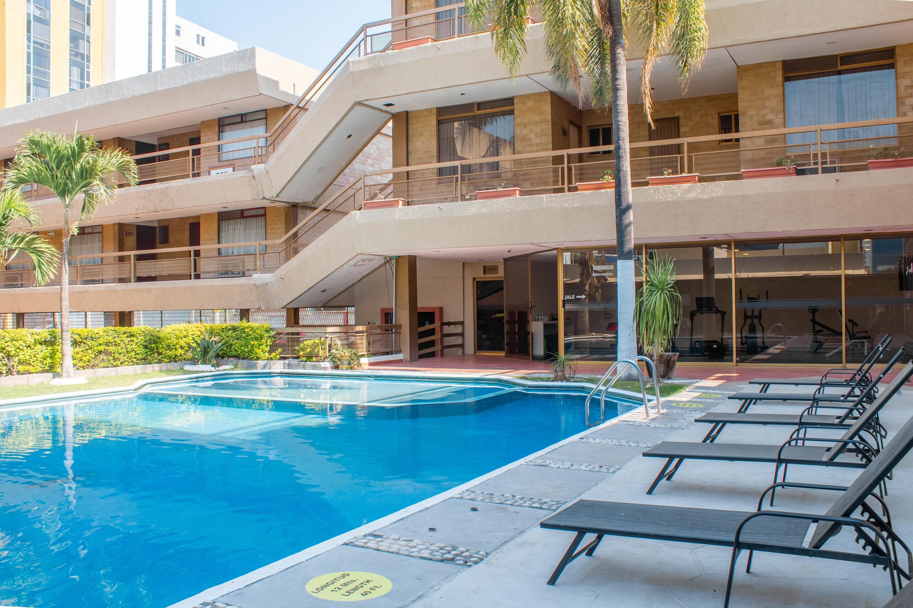 Outdoor pool, open 8:00 AM to 8:00 PM, pool loungers