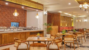 A restaurant with wooden furniture, a buffet counter, and decorative wall patterns. - Nirmala Heritage Hotel (Jimbaran)