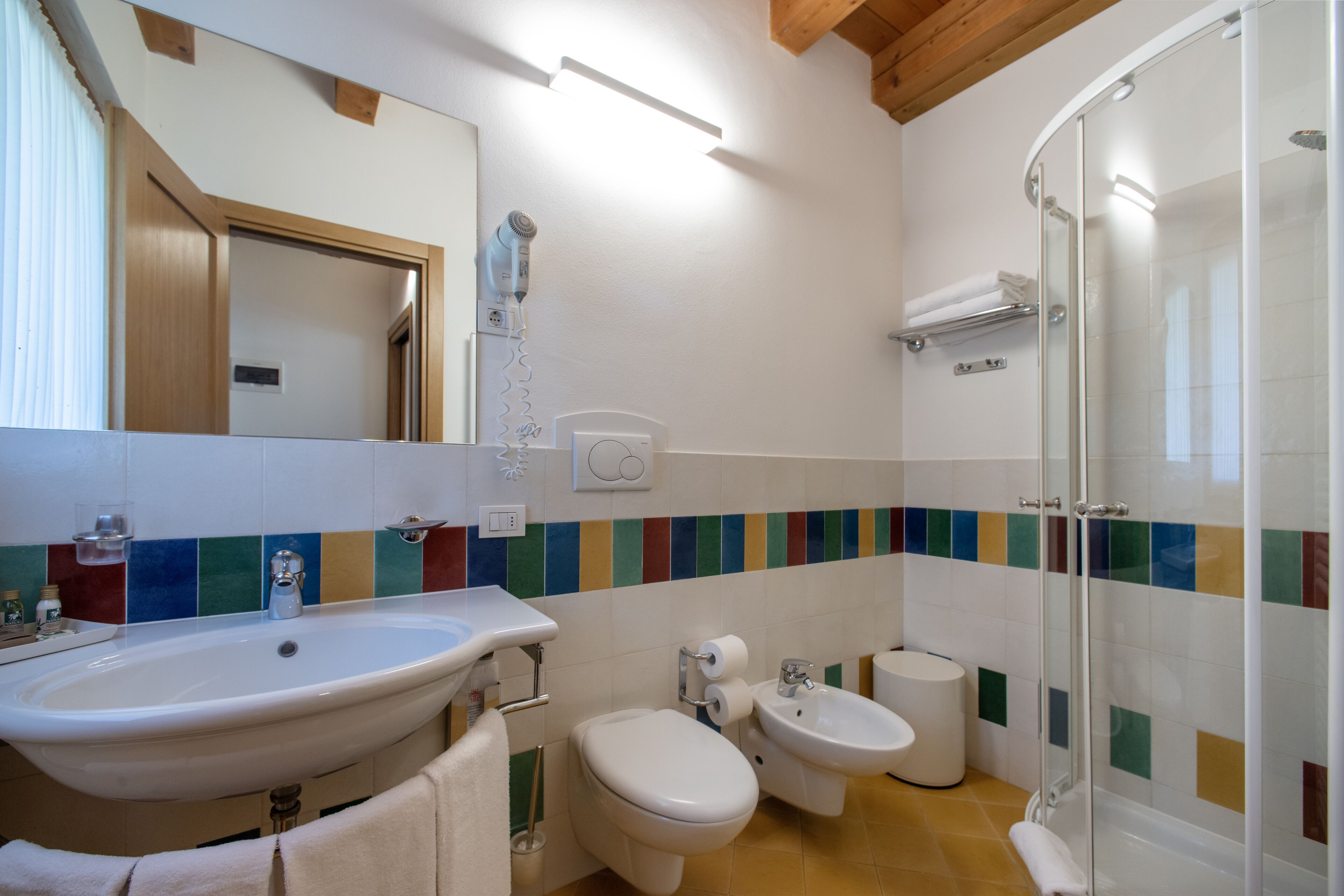 Une salle de bain équipée d’un lavabo, de toilettes, d’un bidet et d’une douche.