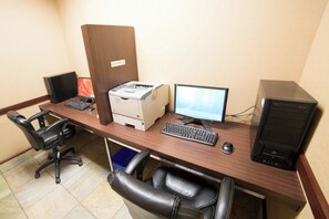 A workspace with two computers, a printer, a keyboard, a mouse, and a chair. - Holiday Inn Hotel & Suites West Edmonton by IHG (Edmonton)