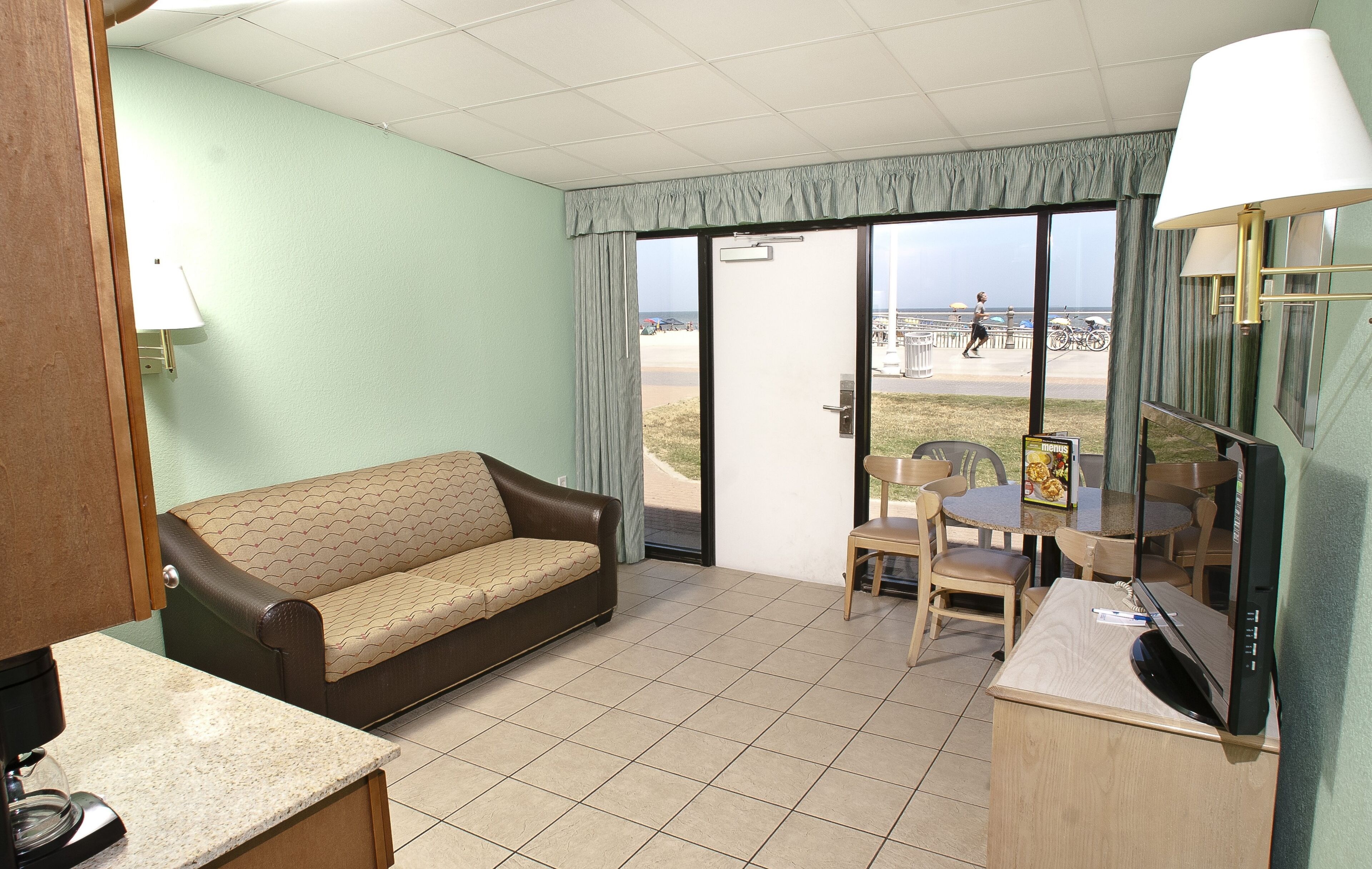 deluxe room, 2 double beds, ocean view | living area | tv