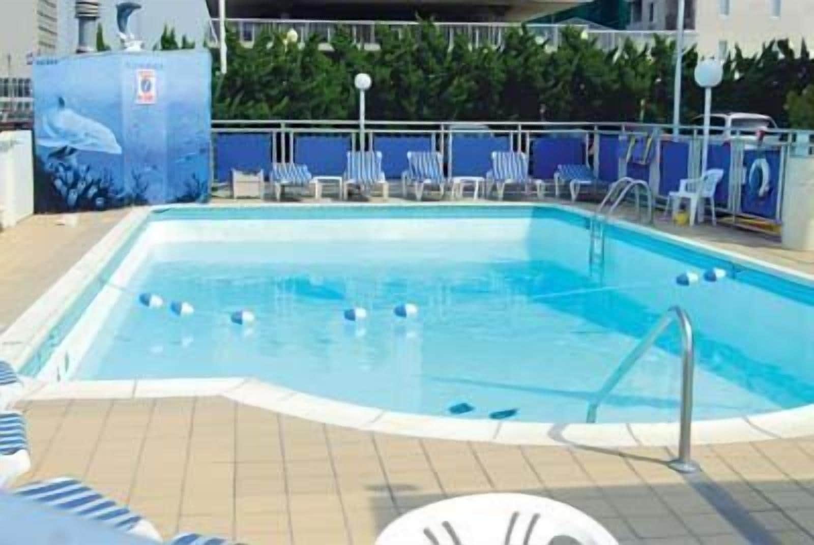 seasonal outdoor pool, open 10:00 am to 10:00 pm, pool umbrellas