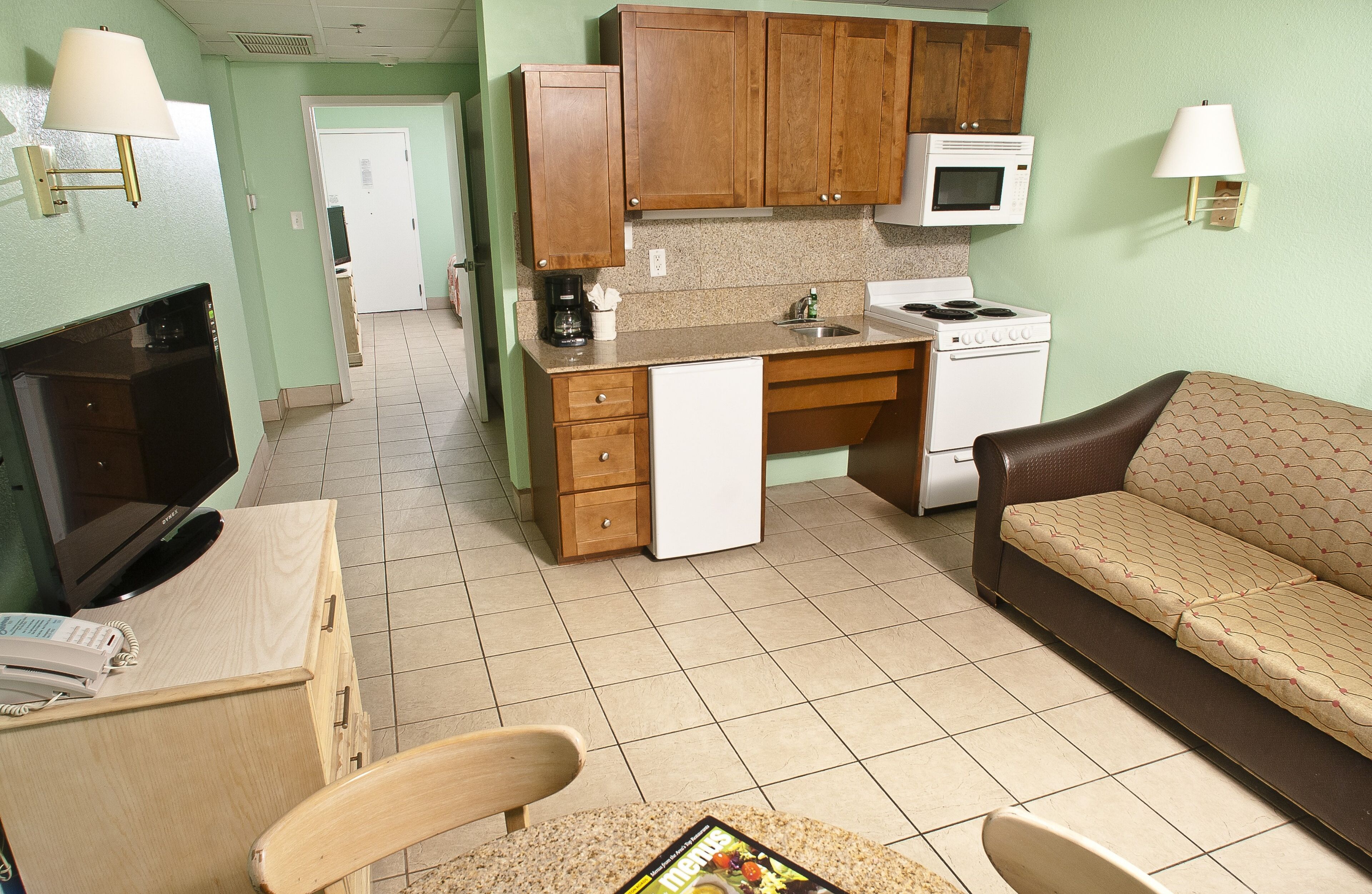 deluxe room, 2 double beds, ocean view | living area | tv