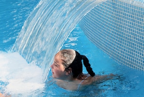 A person swimming in a pool with a clear water feature. - Acapulco (Lloret de Mar)