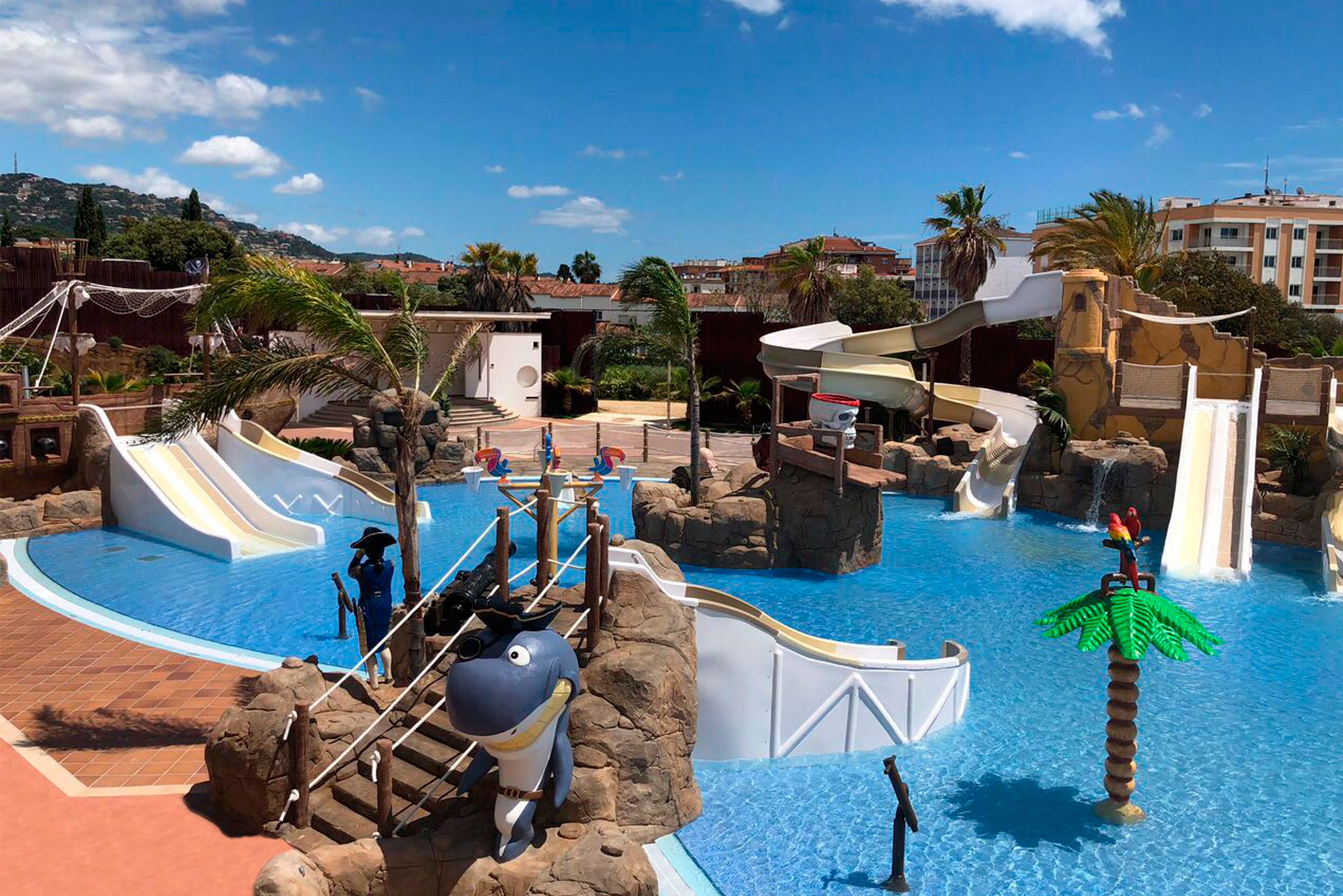 A water park with slides, a pool, and palm trees.