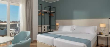 A hotel room with a bed, two bedside tables, a chair, a desk, and a wardrobe.