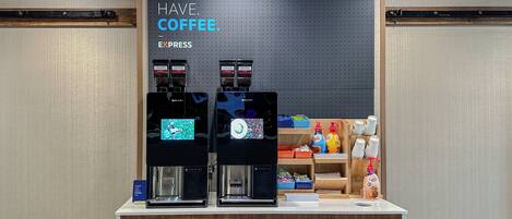 A coffee station with two espresso machines and a sign that reads "MUST HAVE COFFEE."