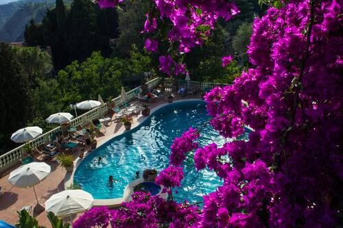 Outdoor pool, open 9 AM to 7 PM, pool umbrellas, pool loungers
