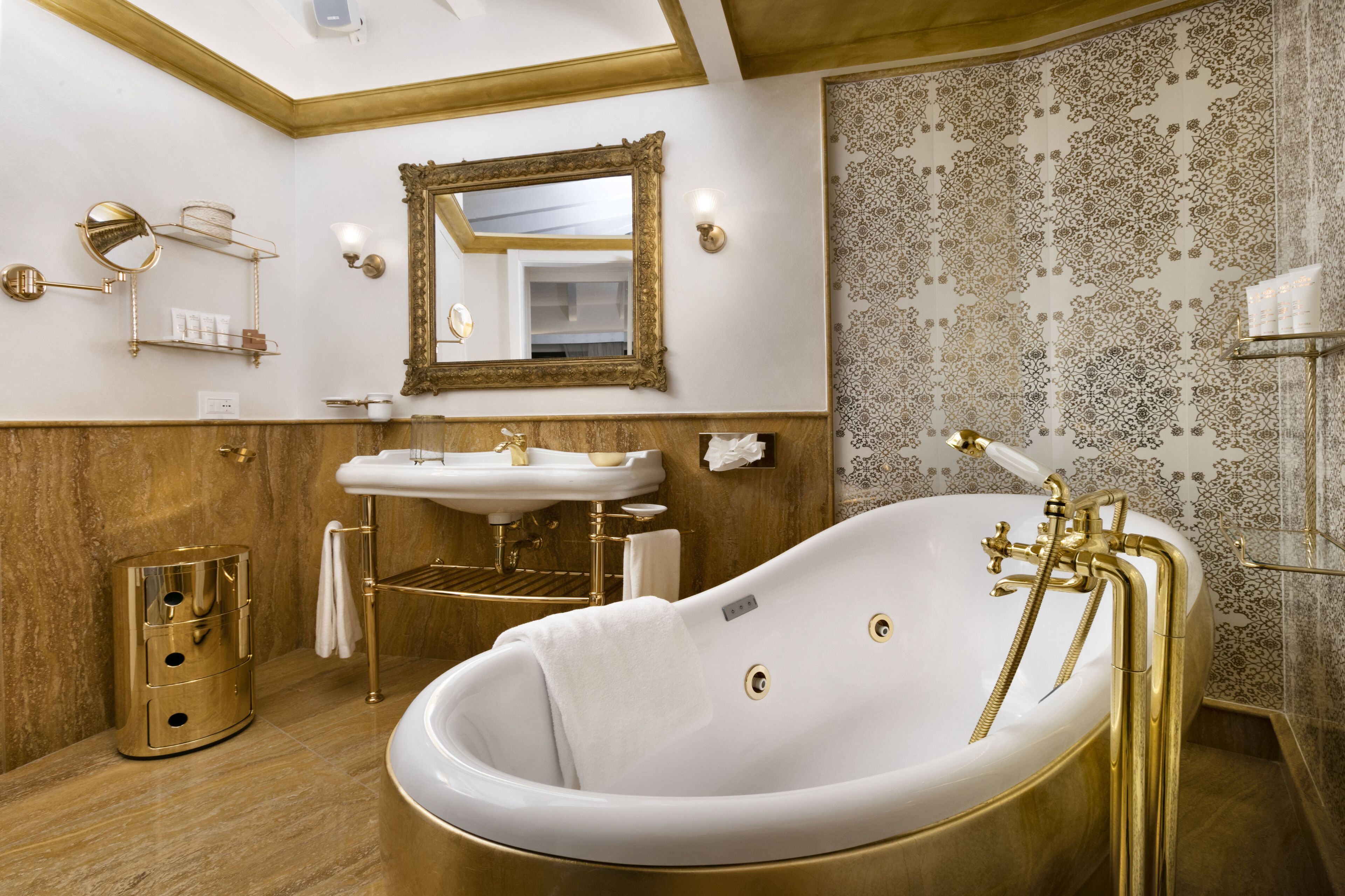 A luxurious bathroom with a freestanding bathtub, a vanity with a mirror, and a wall-mounted towel rack.
