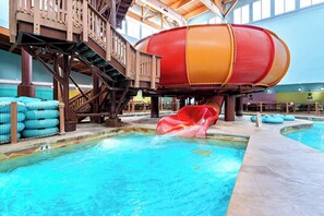 En indendørs vandrutsjebane med en trækonstruktion og en swimmingpool.