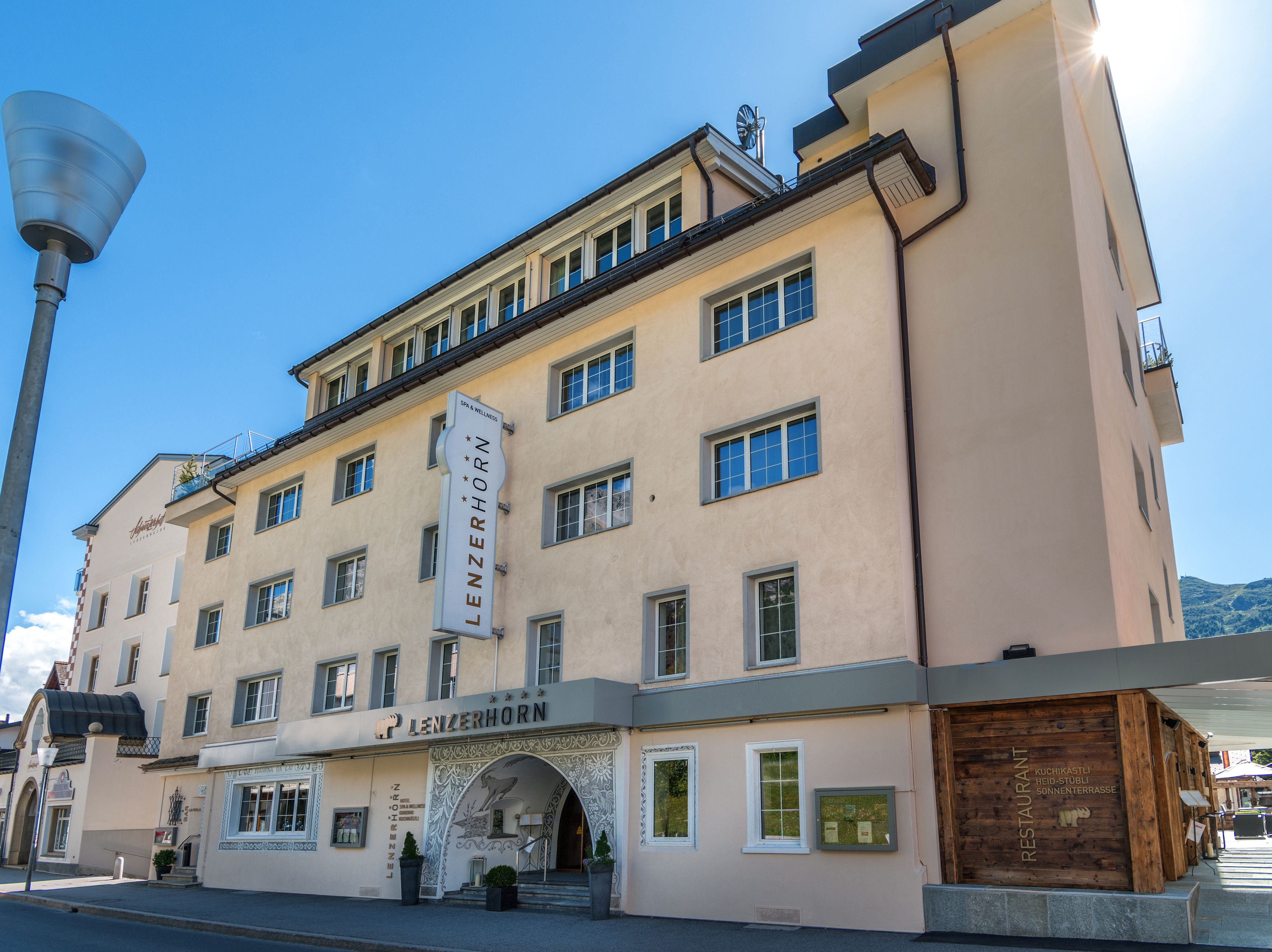 A multi-story building with a prominent sign reading "LENZERHORN."