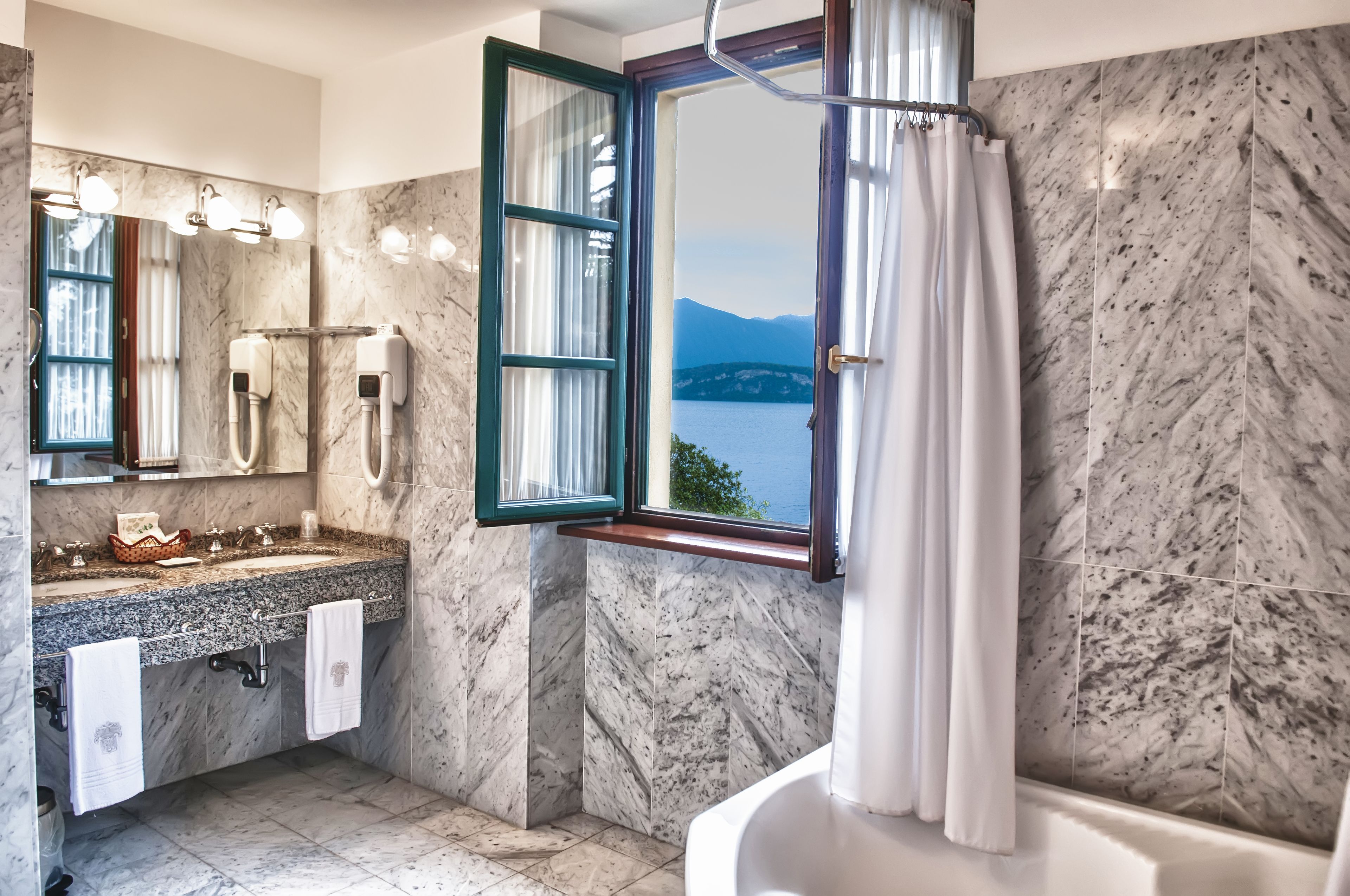 deluxe double or twin room, 1 king bed, lake view | bathroom | designer toiletries, hair dryer, bathrobes, slippers