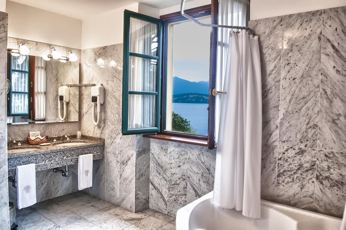 deluxe double or twin room, 1 king bed, lake view | bathroom | designer toiletries, hair dryer, bathrobes, slippers