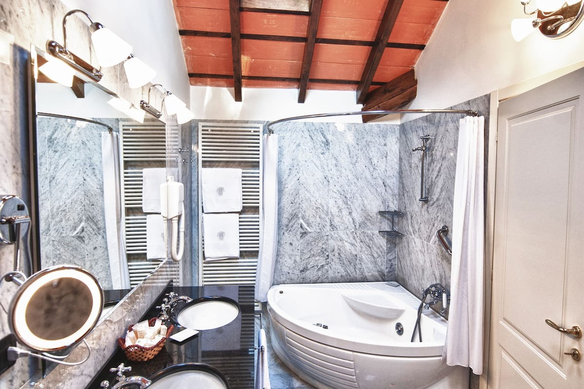 family suite, 1 bedroom, lake view, lakeside | bathroom | designer toiletries, hair dryer, bathrobes, slippers