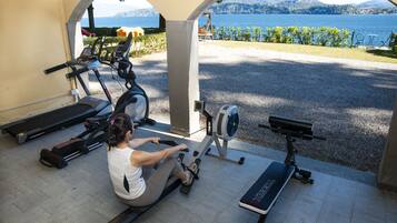 A gym with exercise equipment including a rowing machine, a stationary bike, and a treadmill.