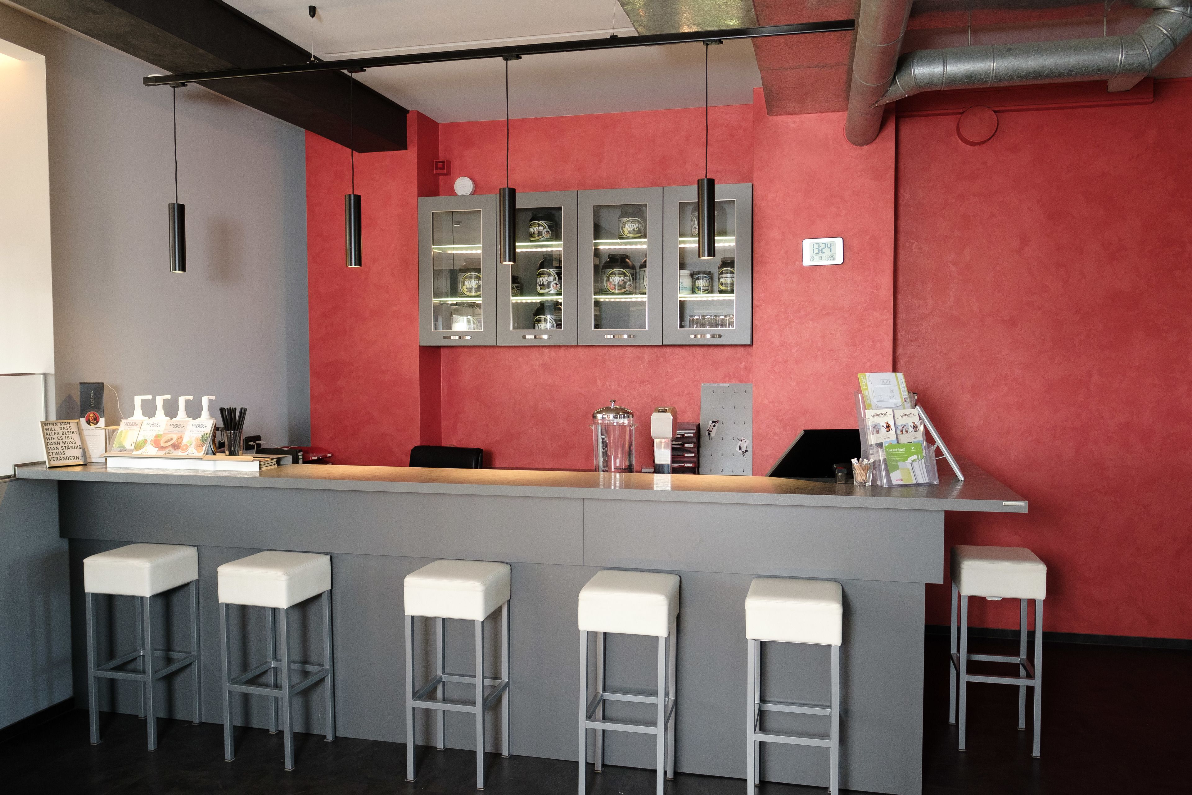 A bar area with a counter, stools, and a display cabinet.