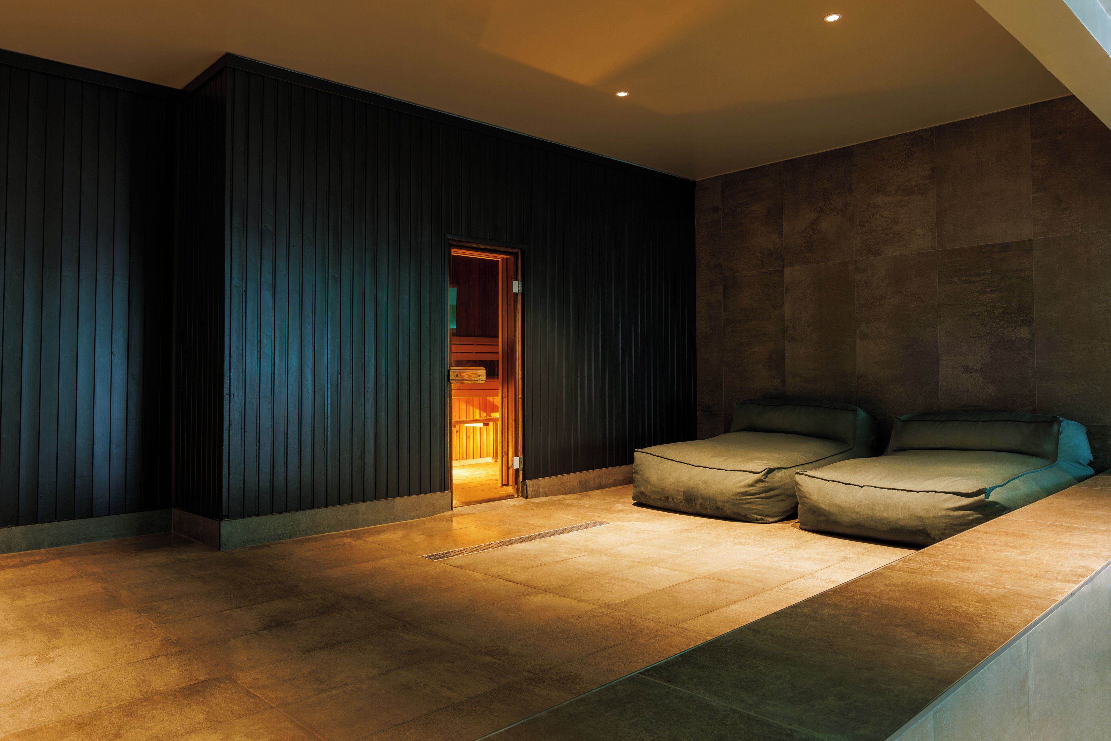 A modern bedroom with a built-in wardrobe, a large bed, and a view of the room.