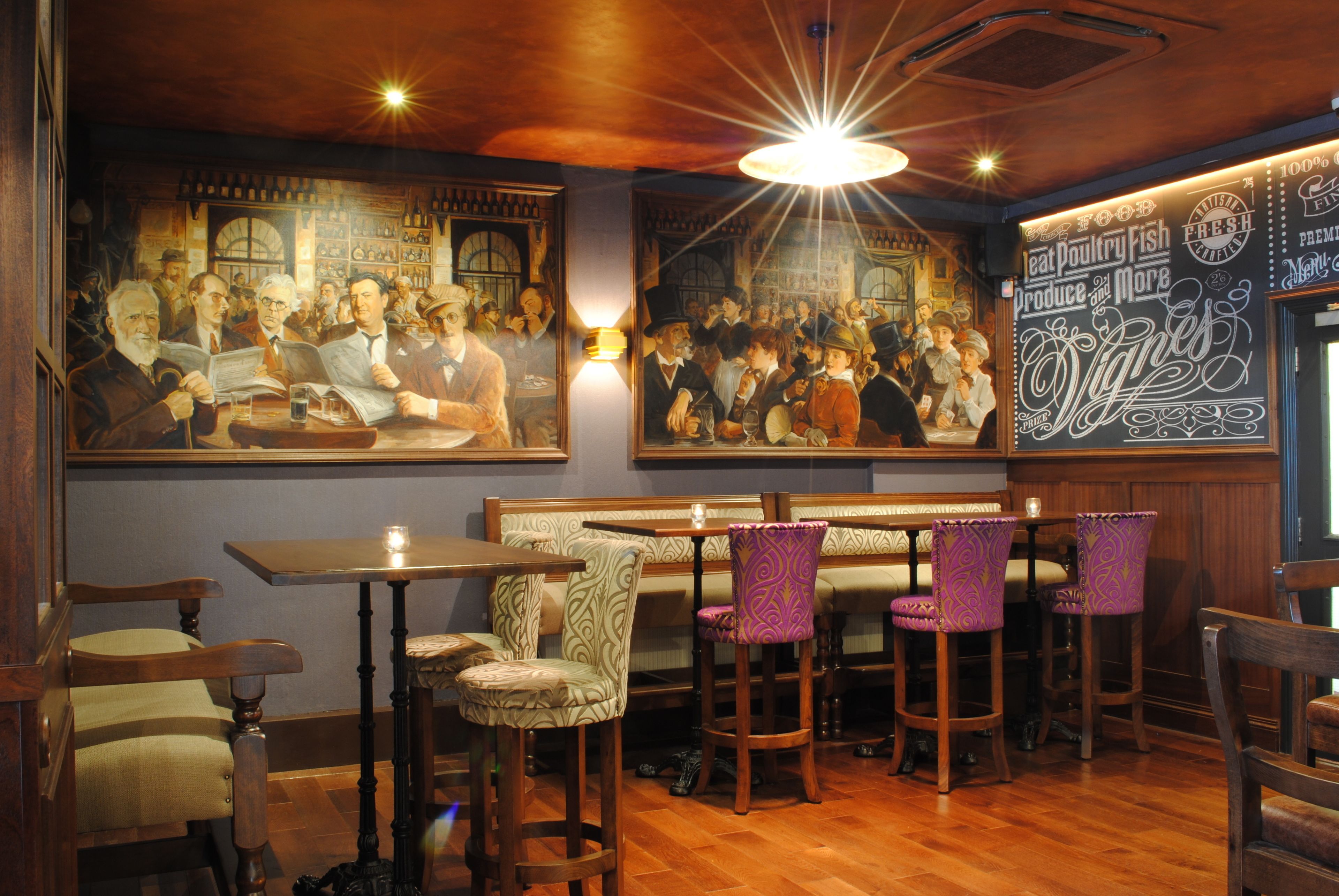 A restaurant interior with wooden tables and chairs, a mural on the wall, and a menu board.