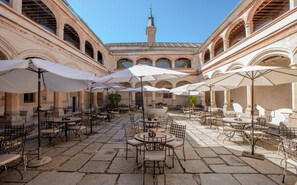 Relax in a serene courtyard with a traditional fountain and outdoor seating.