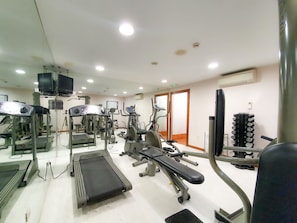 Stay fit on the go with a fully equipped gym featuring treadmills, elliptical trainers, and weight machines.