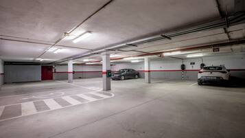 A multi-level parking garage with clear signage, concrete floors, and a wheelchair-accessible area.