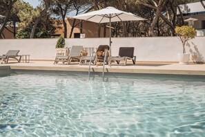 Seasonal outdoor pool, open 10:00 AM to 8:00 PM, pool umbrellas