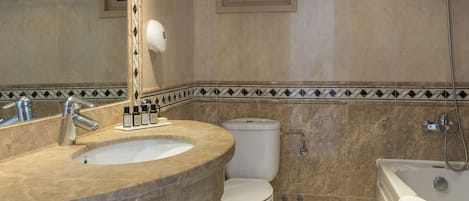 A bathroom with a sink, toilet, and bathtub.