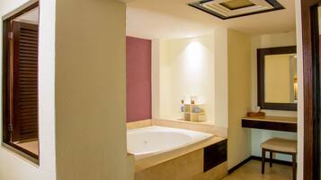 A bathroom with a bathtub, a vanity with a mirror, and a shelf with toiletries.