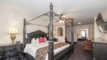 A four-poster bed with a canopy, a nightstand with a lamp, a dresser, and a mirror on the wall.