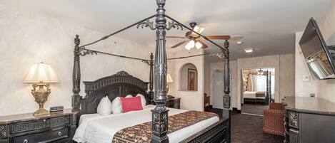 A four-poster bed with a canopy, a nightstand with a lamp, a dresser, and a mirror on the wall.