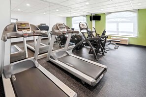 A gym with treadmills, ellipticals, and stationary bikes. - Spark by Hilton Woodbridge (Woodbridge)
