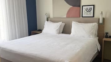 Hypo-allergenic bedding, desk, laptop workspace, blackout drapes