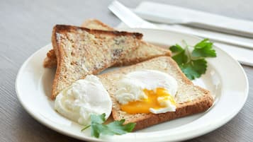 A plate with two slices of toast and a poached egg on a white plate.